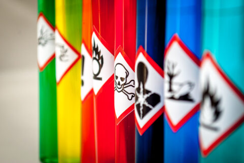 hazardous chemical agents regulations - various surfaces with hazardous material stickers on.