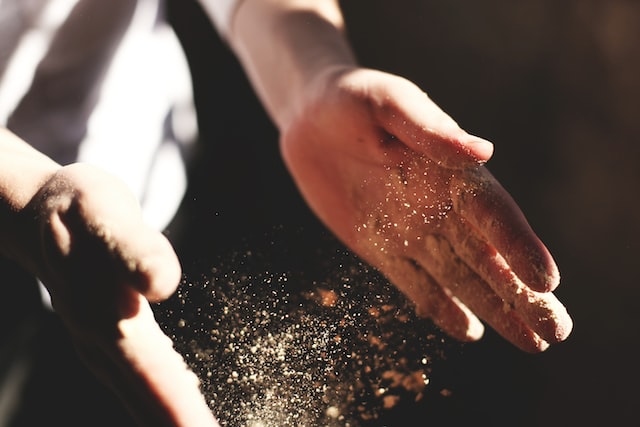 what is silica dust - person clapping hands with visible dust particles