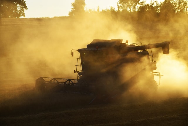 dust management services - combine harvester creating dust while in operation.