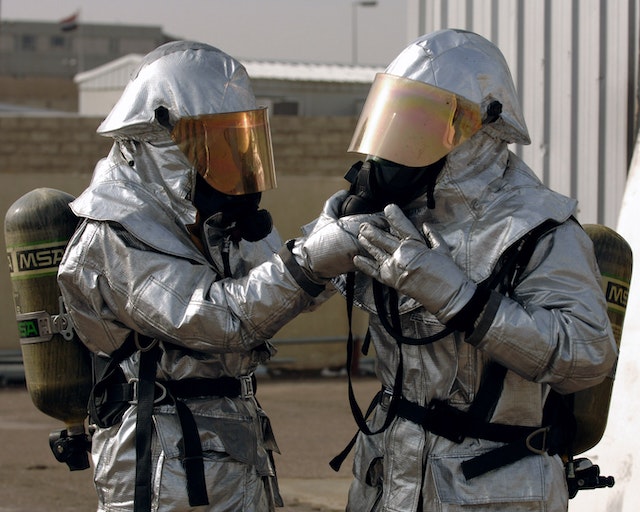 Increase asbestos removal efficiency - image of two workers in protective equipment outdoors