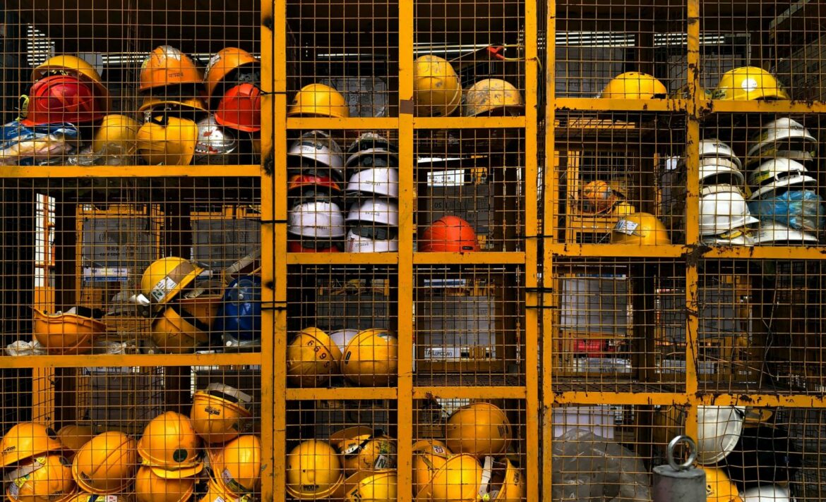 Creating a Safe and Healthy Workplace: A Comprehensive Guide to Essential Employee Training Courses - hard hats in a cage locker