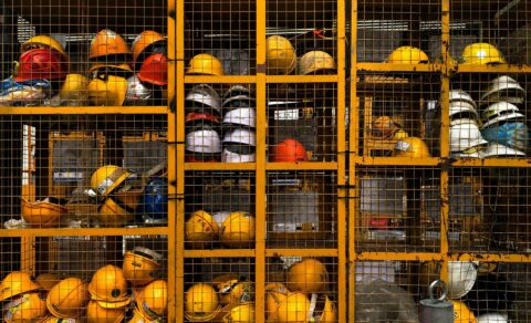 Creating a Safe and Healthy Workplace: A Comprehensive Guide to Essential Employee Training Courses - hard hats in a cage locker