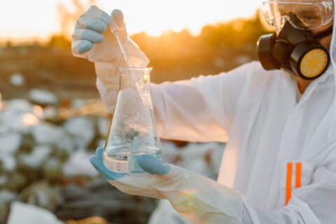 specialist holder a beaker during a water testing procedure