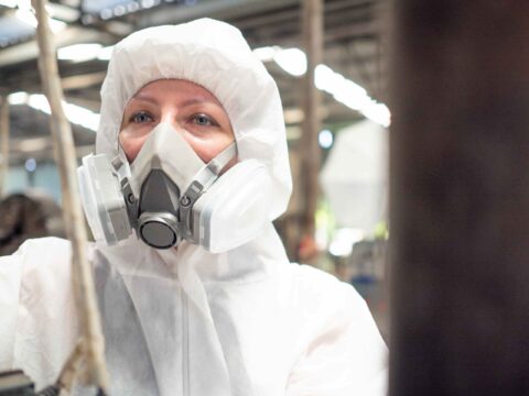Occupational hygiene specialist in full PPE during asbestos training in South Africa, ensuring compliance with safety regulations and exposure control.
