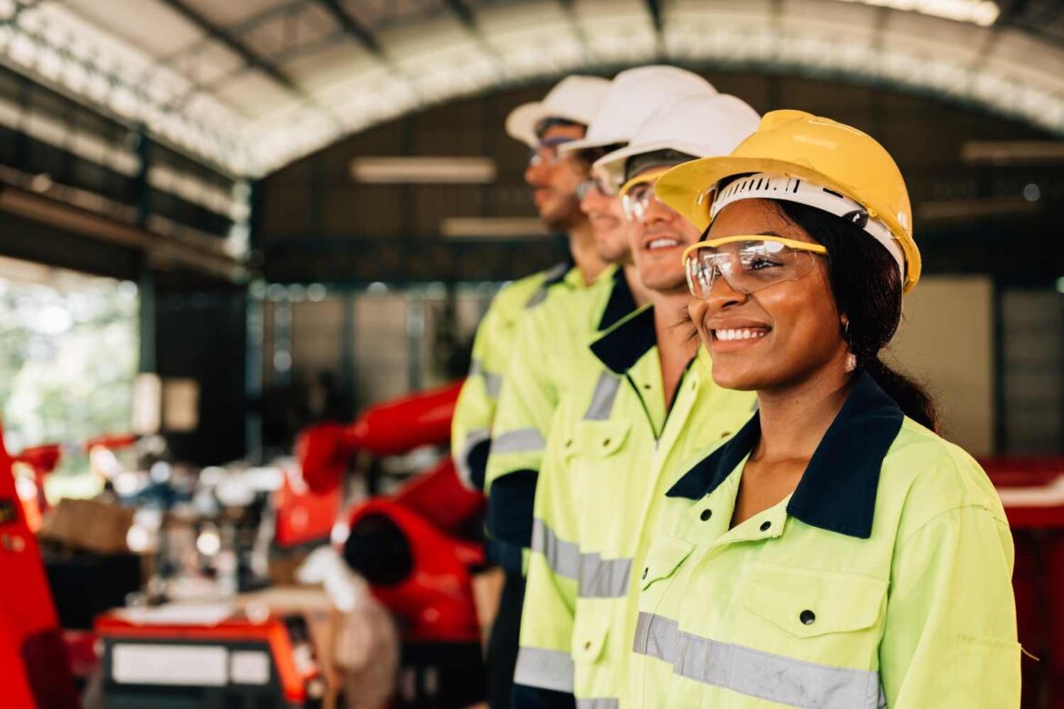 Industrial workers wearing protective gear during thermal stress training in a high-heat work environment