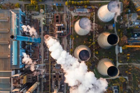 Emission testing in South Africa showing industrial plant stacks releasing monitored emissions into the atmosphere