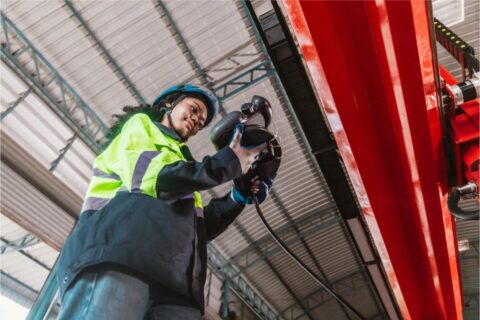 Technician conducting vibration risk assessments on industrial pipework using handheld monitoring equipment