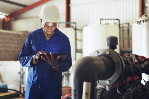 Technician performing an emissions test on industrial equipment to monitor environmental compliance